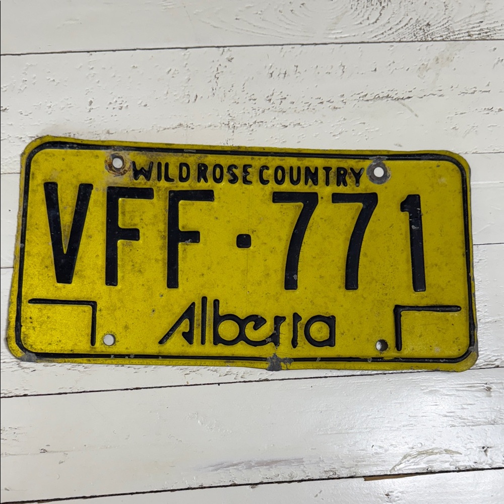 This is a vintage Alberta license plate from the "Wild Rose Country 1975 b1984.